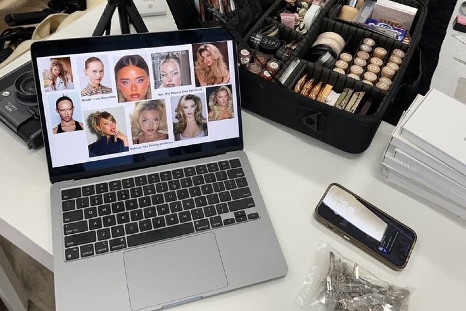 Makeup kit and reference board on a desk